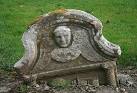 This collapsed gravestone displays the winged soul, an emblem of immortality - via Daymix