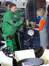 Inga Preuss offering a drink to two policemen with bycicles.