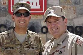 KANDAHAR AIRFIELD, Afghanistan — Julio (right), and 1st Lt. Francisco Arocho, father and son, reunite here, April 15, 2012. Both are currently deployed to ... - 120415-A-CE999-001