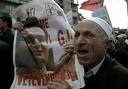 A Kosovo Albanian man holds a portrait of Albin Kurti, the leader of a ... - 71751a5fcf26c48102c817494254-grande