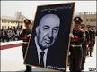 Afghan army officers carry a portrait of former president Mohammad Daud Khan ... - _45573860_daud_khan226afp