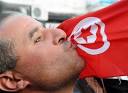 A man kisses the Tunisian flag