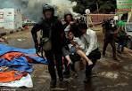 Egyptian woman attempts to stop military bulldozer from running.