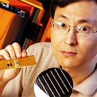 Graduate Research Assistant Bing Dang holds a silicon wafer containing chips built with microchannels, and (left) an organic printed circuit board with two ... - LiquidCooling