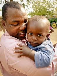 [Papa Lameck with youngest Iris boy]. As we searched for a house mum for Girls &#39;, God opened our eyes to see a woman already working within our community. - Papa_Lameck_with_youngest_Iris_boy_Update_Oct_13-7