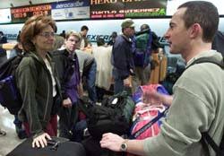 Lily Di Gregorio of Montreal and Ivan Giesbrecht of Calgary stands in line as they are waiting to check-in their bagage at Mexico City Airport before flying ... - thetrip