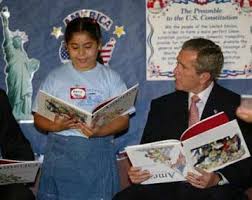 bush reading book upside down