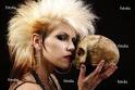 Peter Kim #20383863. A sexy punk rocker woman holding a human skull.