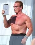 Arnold Schwarzenegger takes selfie during Cannes sunbathing.