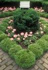 Boxwood garden in tiny setting with bench | Plant & Flower Stock ...