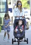 Jessica Alba flashes a smile as daughter Honor bounds ahead on a