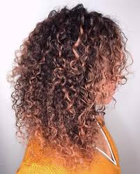 Rose gold highlights on curly hair