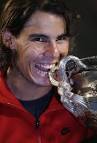 Nadal takes a bite out of the Norman Brookes' trophy eliciting some applause ... - nadal-takes-a-bite-out-of-the-norman-brookes-trophy-eliciting-some-applause-from-the-fans-in-the-stands-after-his-epic-five-set-win-over-federer
