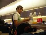 File:Female flight attendant at work on board of a PBair ATR 72