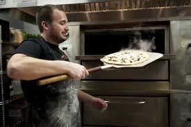 Tony Lemmo, one of the owners of Gusto Pizza, pulling out a divine pie - gusto-pizza-6