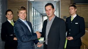 In Riga, Janis Vanags, vice-president, corporate communications, airBaltic hands out a €100 gift certificate to Adrian Besho – the first passenger to ... - airbaltic-1