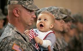 Staff Sgt. Jeremy Horkey holds his nine-month old son, Colton, while standing in formation Wednesday to be dismissed from active duty with the 79th Military ... - welcomehomedaddyImage2
