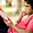 India man sitting reading dictionary, image © British Council - Content_english-exam-preparation-240x240-india-man-sitting-reading-dictionary