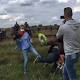WATCH: A Hungarian camerawoman trips refugees who are running from police 