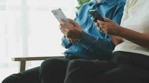 Happy adult man wearing earbuds watching videos on horizontal mobile phone in the street a jpg x Mature mobile phone videos