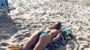 Playfully removing her bikini bottom on the beach jpg x Bikini beach