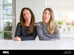 mother daughter tongue|Happy Mother Daughter Sticking Out Tongues Looking Floor Blurred Background  — Stock Photo © VitalikRadko #437769648