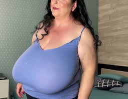 Big breasted woman shows off huge tits jpg x Large breasted women videos