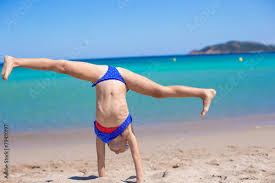 nudist little girl|Little girl in bikini posing on a deserted pebble beach ...