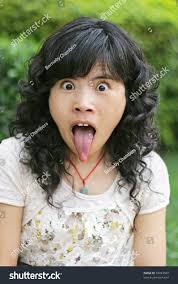 tongue girl|Portrait of blond girl sticking out tongue stock photo