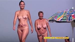 Nudist beach voyeur finds two sexy girls enjoying the sun jpg x Sexy voyeur