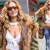 Rita Ora puts on a busty display in a sexy white wrap bra top and ...