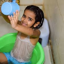 bath child girl|File:Indian girl bathing a child.jpg - Wikimedia Commons