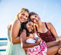 Mother daughter lesbian|Lesbian couple and daughter relaxing on patio - Stock Image - F022/7381 -  Science Photo Library