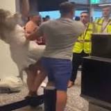 Furious easyJet passenger shoves girlfriend out the way and punches airport staff